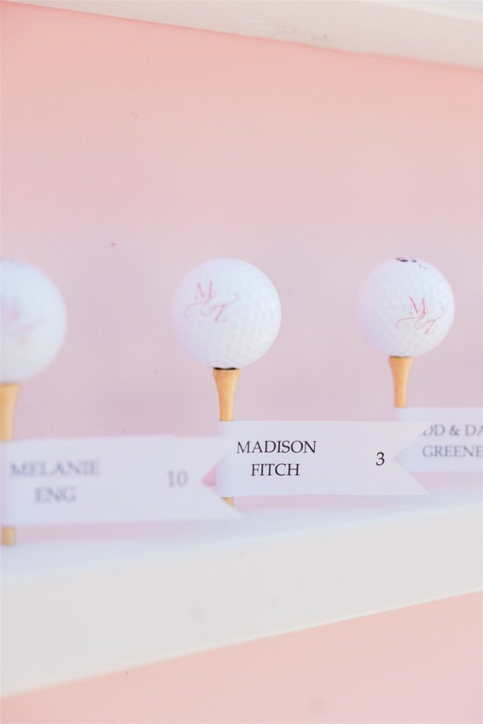 Wedding escort cards arranged for guests with table assignments and meal identifiers for a plated reception.